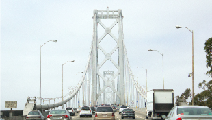 Famed NYC Bridge’s Armor Is Focus of Suit Against French Company Bridge with cars in traffic