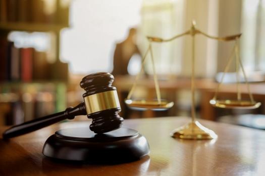 Gavel with scales of justice in background