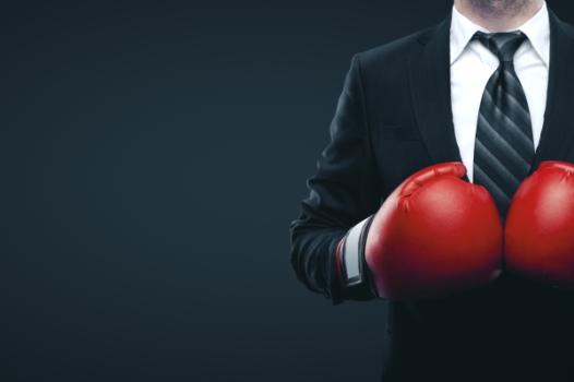 Businessman wearing boxing gloves