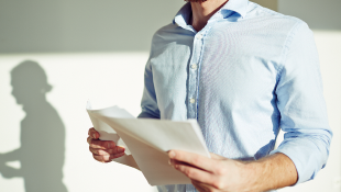 Risk-Shifting Tactics for Construction Contracts Businessman holding contract