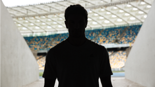 Workers at Two NFL Stadiums Test Positive for COVID-19, But Construction Continues Silhouette man in stadium entrance