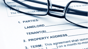 Lease-Leaseback Fight Continues Glasses lying on residential lease agreement