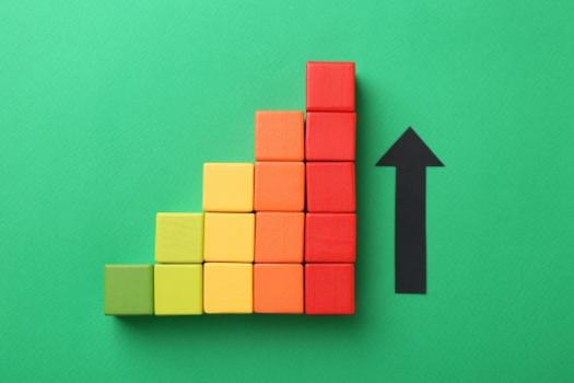 Colored blocks increasing in height arrow up