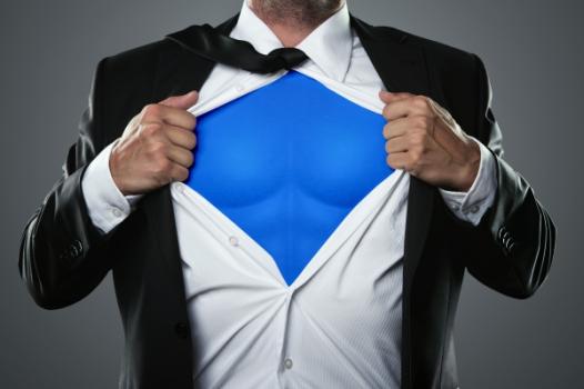 Business person opening suit like superhero