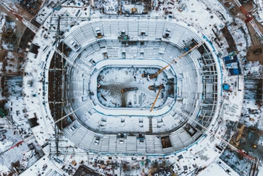Aerial view of snowy stadium cranes