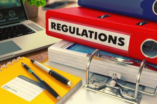 Call Me Maybe: California’s Fair Claims Settlement Practices Regulations Red regulations folder next to notebook and laptop