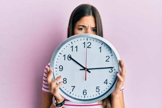 Woman holding clock