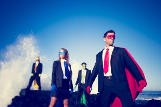 Business people with superhero capes