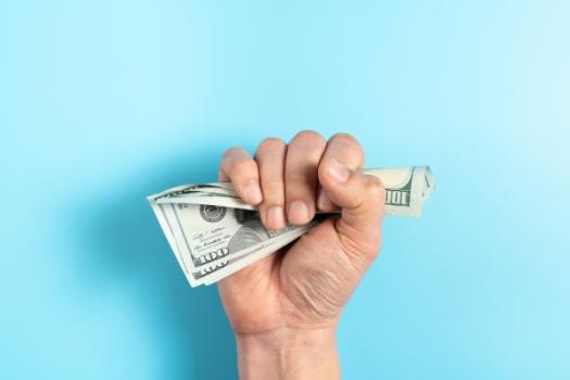 Hand clenching money