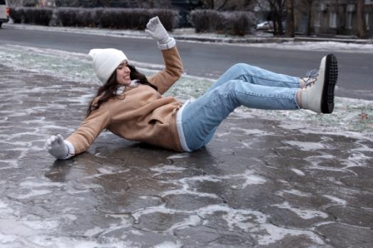 Woman falling on icy concrete