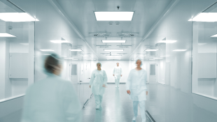 COVID-izing Your Construction Contract Medical staff walking through corridors