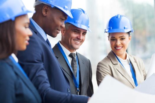 Businesspeople in hardhats meeting