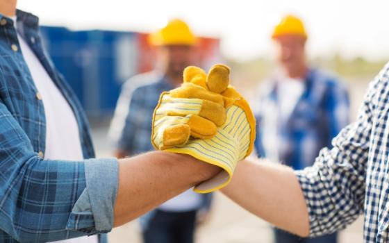 Construction workers shaking hands