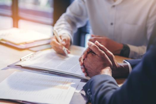 Two people meeting over contract