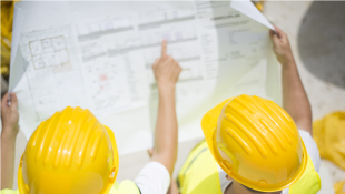 Two construction workers looking at plans