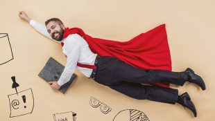 Businessman wearing cape and flying