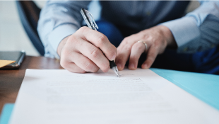 Waiver of Consequential Damages: The Most Important Provision in a Construction Contract Businessman signing document