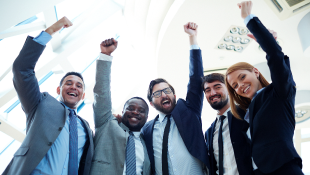 Group of business people with arms raised in triumph