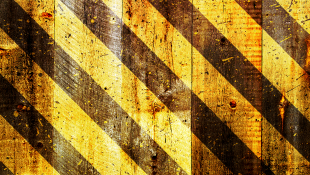 Construction stripes on wooden background