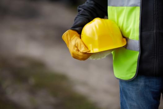 Construction worker holding hard hat
