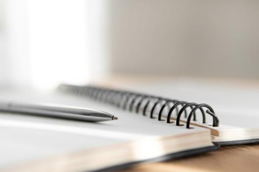 Pen resting on notebook
