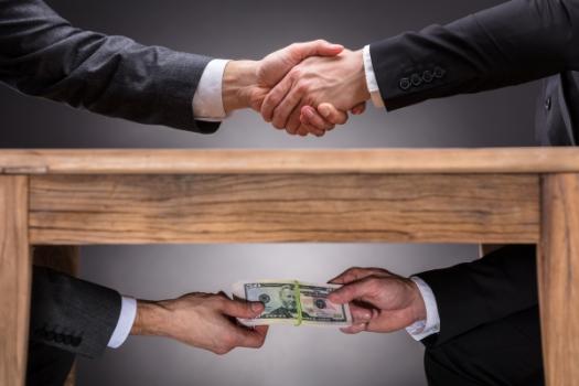 Money exchanged under a table