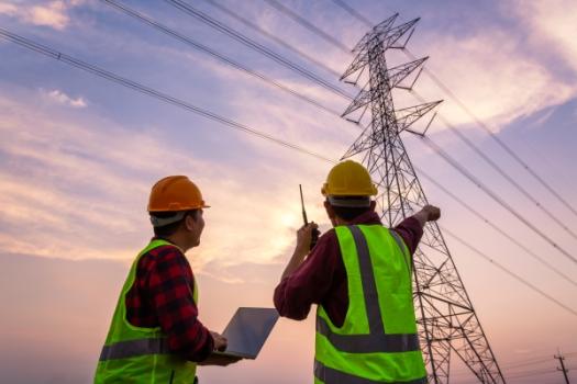 2 Workers Looking at Powerlines