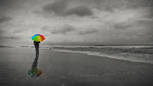 Woman holding umbrella on beach