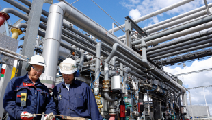 MDL for Claims Against Manufacturers and Distributors of PFAS-Containing AFFFs Focuses Attention on Key Issues Two construction workers talking in front of pipelines