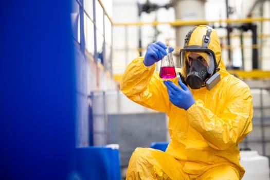 Person in chemical suit in warehouse