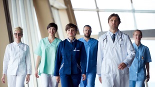 COVID-19 Vaccine Considerations for Employers in the Construction Industry Medical staff walking through corridors