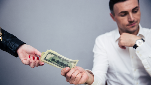 Henkels & McCoy Pays $1M in Federal Overtime-Pay Case Businessman handing someone money
