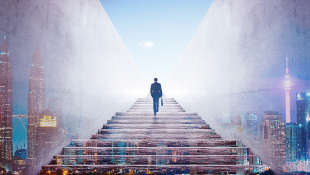 Businessman climbing stairs with city behind image