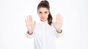 Court Dismisses Coverage Action In Lieu of Pending State Case Businesswoman with hands up in warning stop