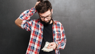 New York Considers Amendments to Construction Industry Wage Laws that Would Impose Significant Burden Upon Contractors Confused man looking down at money worried