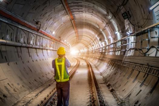 World's Longest Immersed Tunnel Passes Milestone, But Faces Delays Tunnel with worker in it
