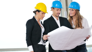 Three people looking at plans