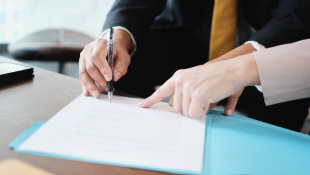 Benefit of the Coblentz Agreement and Consent Judgment Person pointing where to sign document