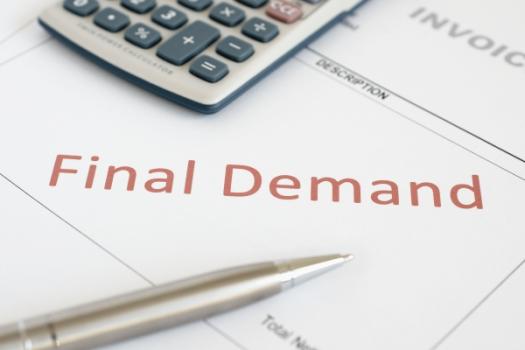Contractor Sues for $5.7M in Pay for Iowa Jail Project Final Demand next to calculator and pen