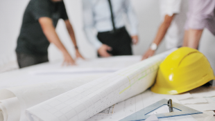Differing Site Conditions: What to Expect from the Court When You Encounter the Unexpected Architects meeting over plans and hardhat