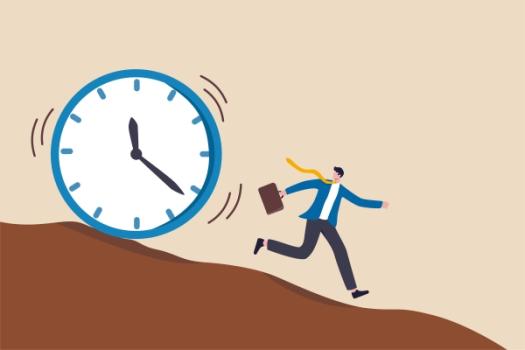 Man running from clock rolling down hill