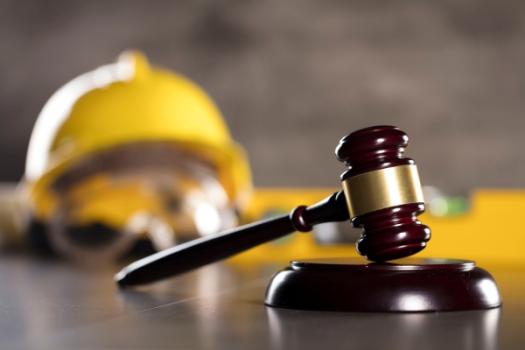 Gavel with hardhats in background