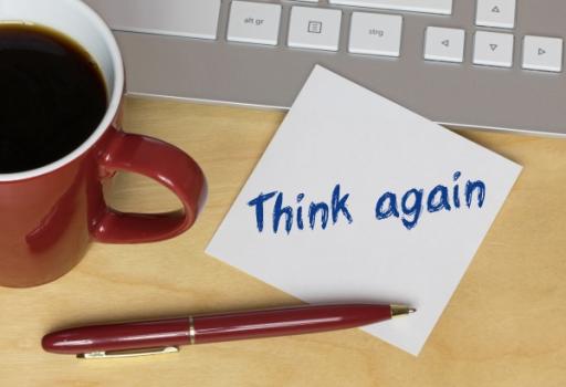 Dispositive Motions in AAA Construction Arbitration: Why You Should Think Twice Post it says Think Again next to computer and coffee