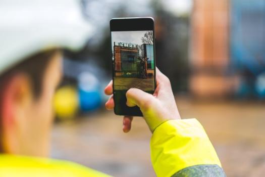 A Lesson from the Criminal Courtroom to Construction Contractors About Videos and Photos Worker taking video with cell phone