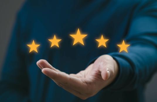 Best Lawyers Honors Hundreds of Lewis Brisbois Attorneys, Names Two Partners “Lawyers of the Year” Hand holding five gold stars
