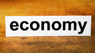 Economy text on wood background