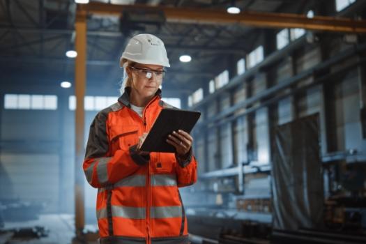 Construction worker holding clipboard