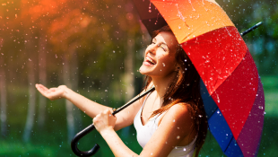 Laughing woman under umbrella