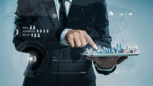 A Networked World of Buildings Businessman with finger on digital model