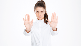Businesswoman holding hands up in stop gesture